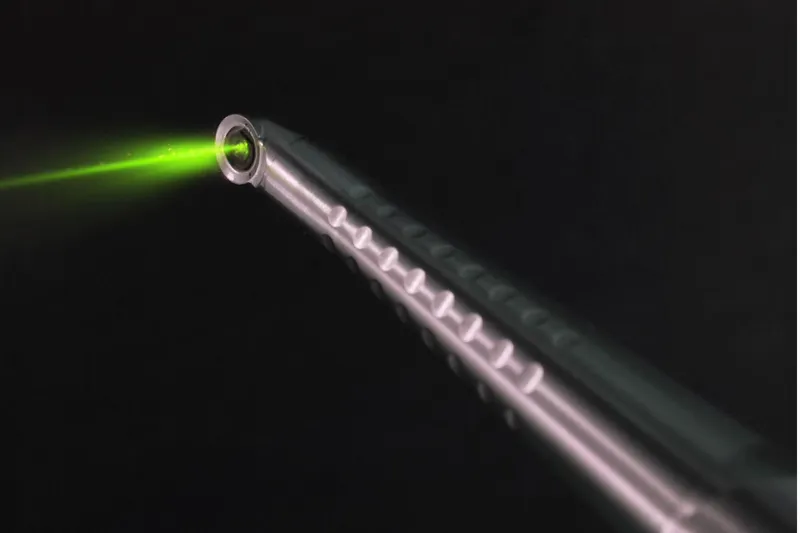 The Fotona dental laser handpiece, showing its precise green targeting beam