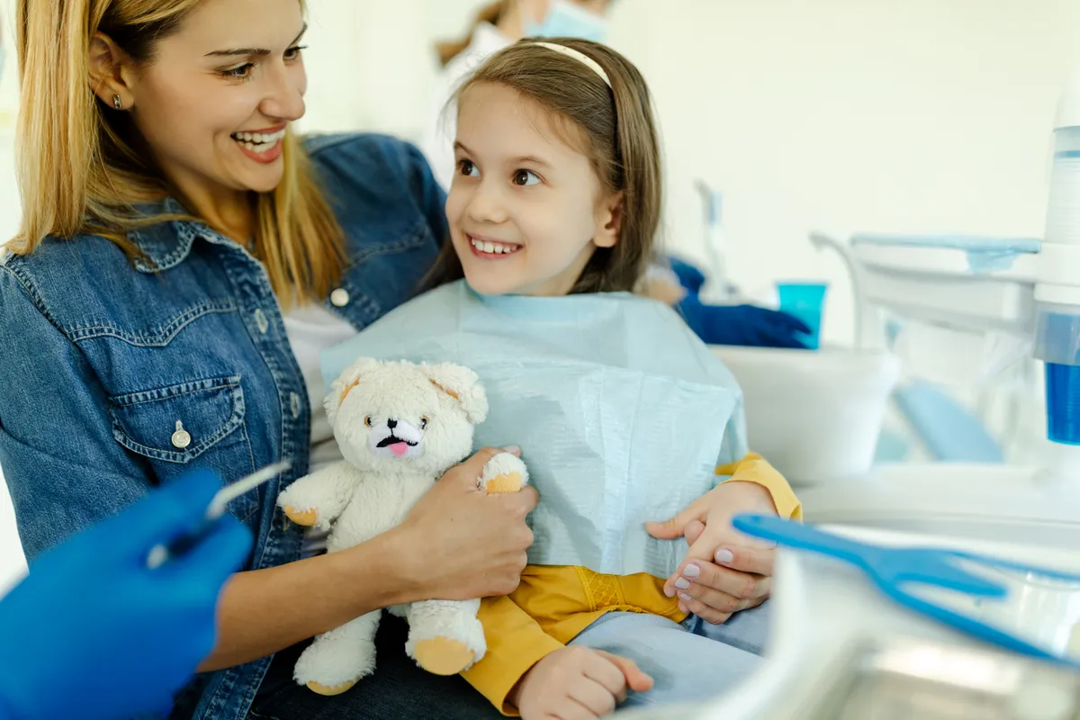 A young girl sitting comfortably in the dental chair.