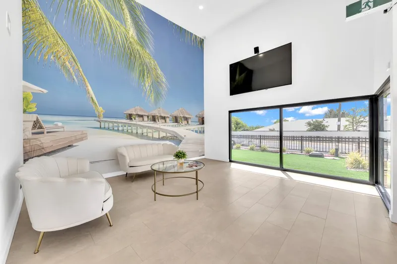 A waiting area with a palm tree wall feature