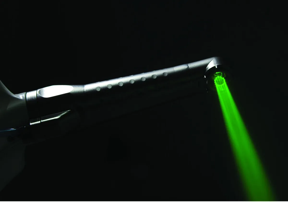 Fotona LightWalker green pilot beam emerging from the handpiece on a black background