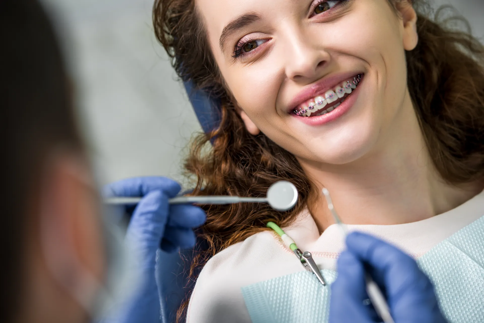 A cheerful woman with braces during a dental examination